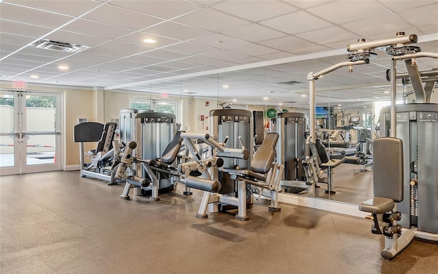 gym featuring visible vents, a drop ceiling, and french doors