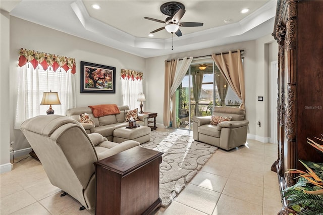 living room with ornamental molding, a tray ceiling, and plenty of natural light