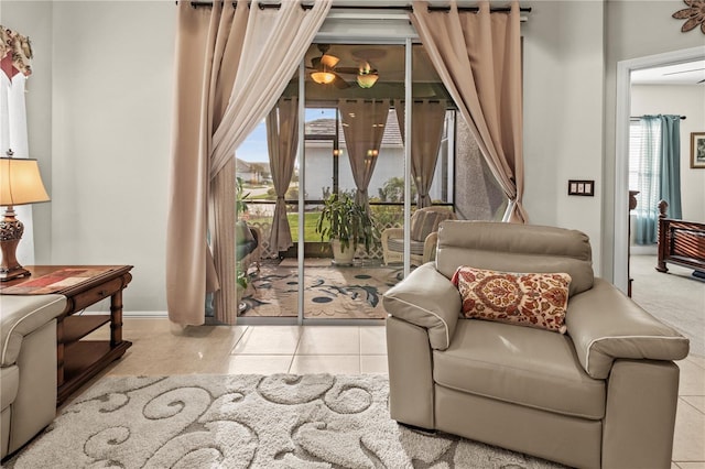 sitting room with baseboards and tile patterned floors