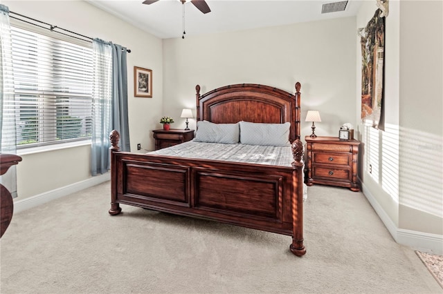 bedroom featuring light colored carpet, visible vents, and baseboards