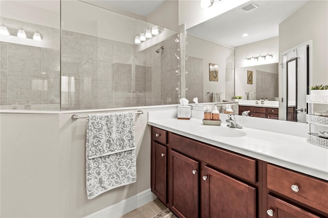 full bath featuring tile patterned floors, visible vents, vanity, and a walk in shower