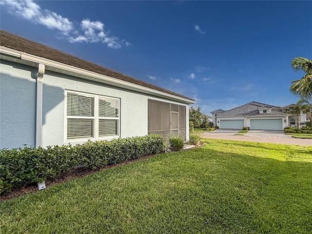 view of side of home with a lawn and stucco siding