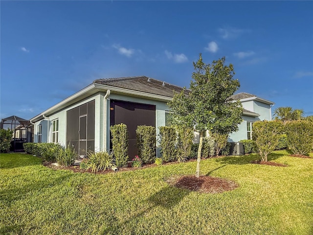 view of home's exterior featuring a lawn and stucco siding