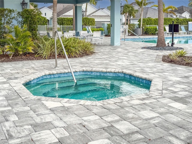 pool with fence and a patio