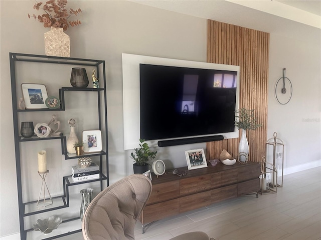 living area featuring wood finished floors and baseboards