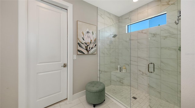 full bath with tile patterned flooring, a shower stall, and baseboards