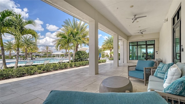 view of patio featuring outdoor lounge area, a ceiling fan, and a community pool