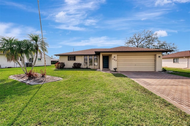 ranch-style house with an attached garage, a front lawn, decorative driveway, and stucco siding