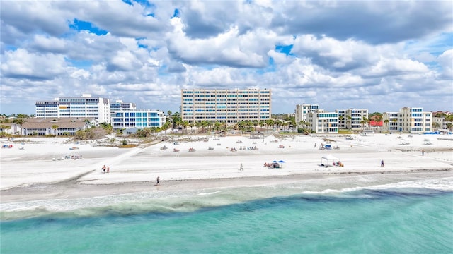 birds eye view of property with a view of the beach, a water view, and a view of city