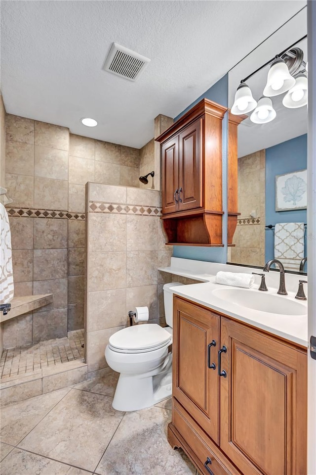 full bathroom featuring toilet, visible vents, walk in shower, and a textured ceiling