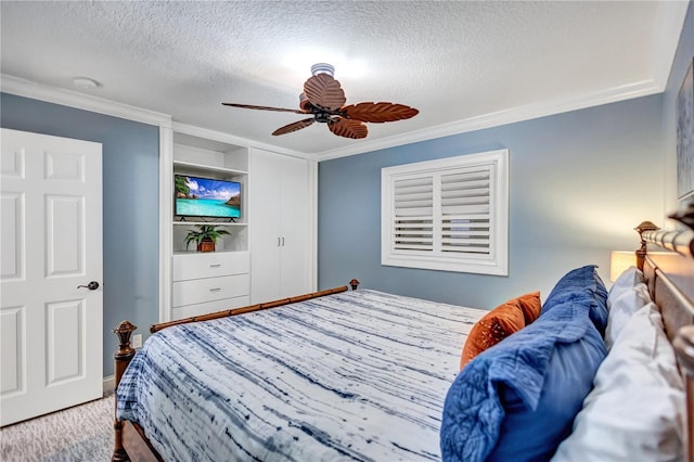 bedroom with ornamental molding, ceiling fan, and a textured ceiling