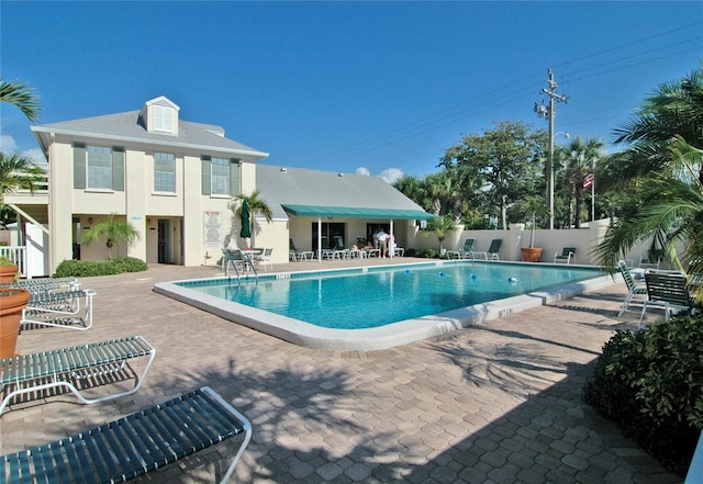 community pool featuring a patio area and fence