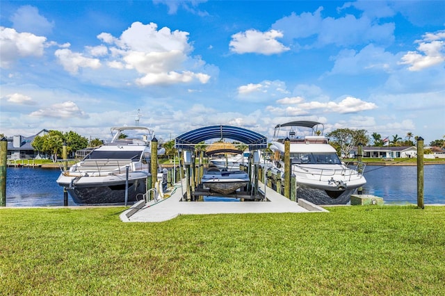 view of dock featuring a water view, a yard, and boat lift