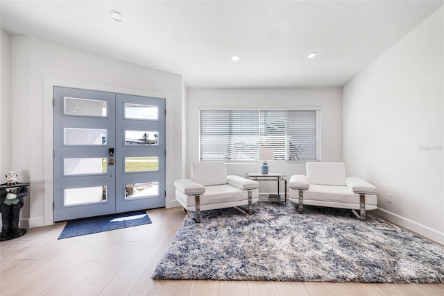 entryway featuring french doors, recessed lighting, wood finished floors, and baseboards