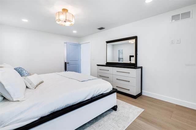 bedroom featuring recessed lighting, light wood-type flooring, visible vents, and baseboards