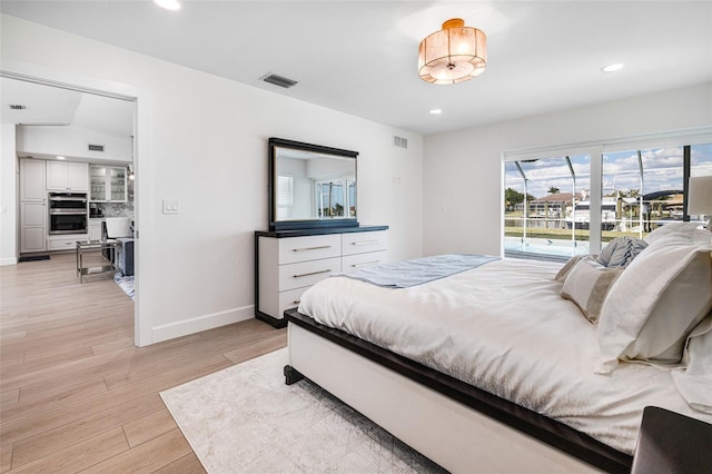 bedroom featuring light wood finished floors, recessed lighting, visible vents, and access to exterior