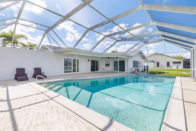 outdoor pool featuring ceiling fan, a patio, and a lanai