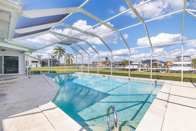 pool featuring glass enclosure, a yard, and a patio