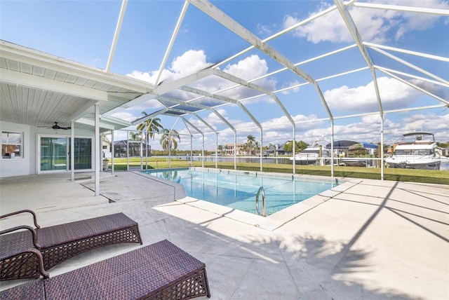 outdoor pool with a lanai, a patio, and ceiling fan