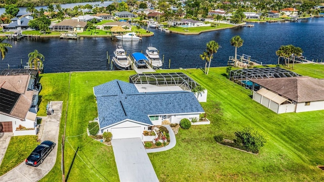 drone / aerial view featuring a water view and a residential view