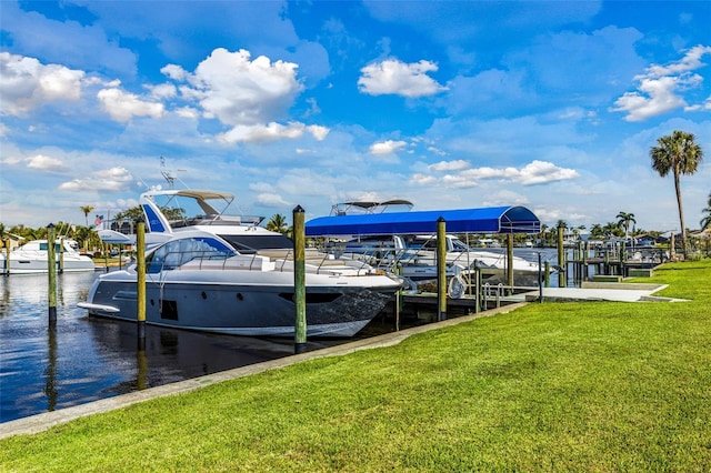 view of dock featuring a water view, a yard, and boat lift