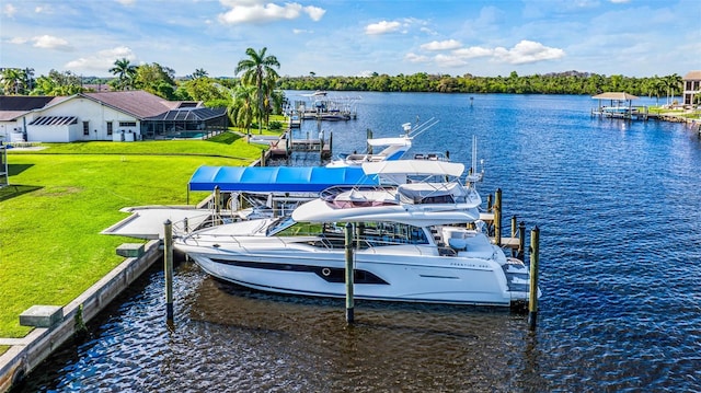 view of dock with a lawn and a water view