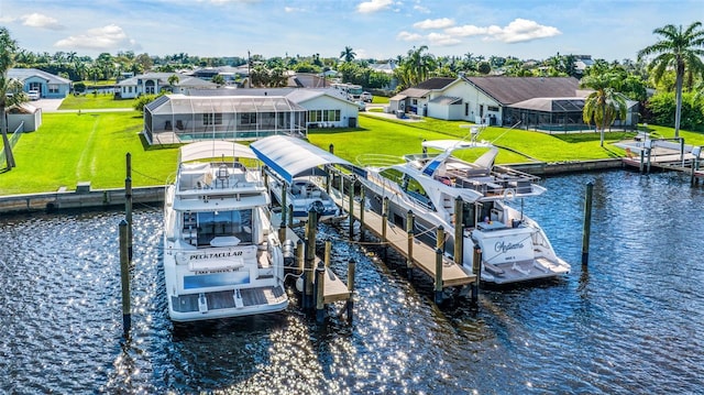 dock area featuring a lawn, a water view, and a residential view