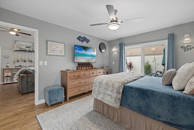 bedroom with ceiling fan, access to outside, wood finished floors, and baseboards