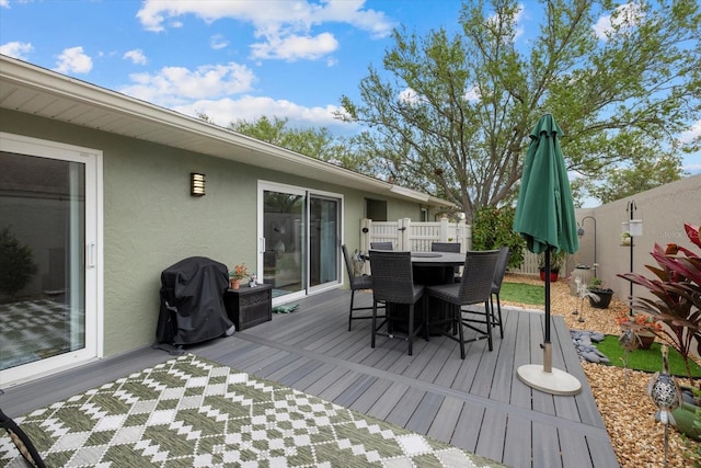 wooden deck featuring fence, outdoor dining area, and area for grilling