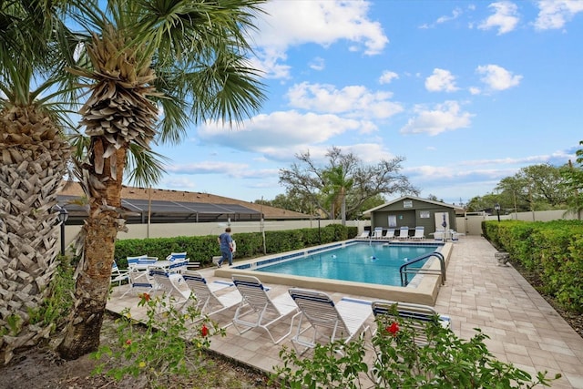 community pool with fence and a patio