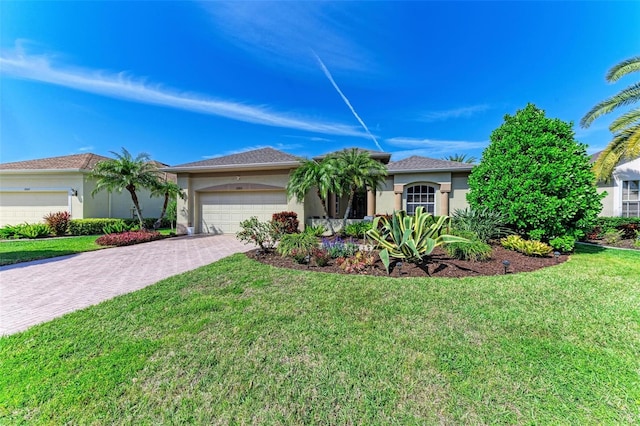 ranch-style home featuring a garage, a front lawn, decorative driveway, and stucco siding