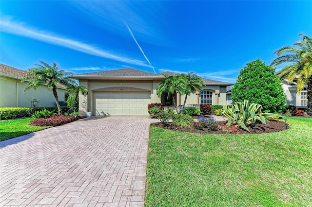 view of front of home with a garage, a front lawn, decorative driveway, and stucco siding