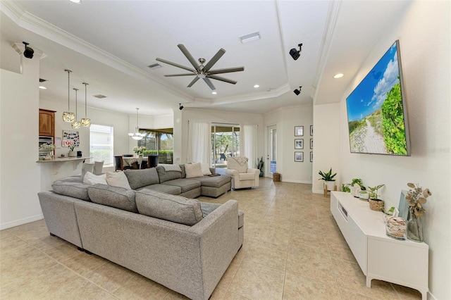 living area with ornamental molding, visible vents, and baseboards