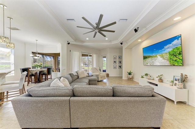 living area with recessed lighting, visible vents, a tray ceiling, and light tile patterned floors