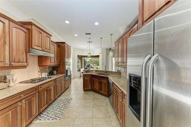 kitchen featuring light tile patterned floors, decorative backsplash, appliances with stainless steel finishes, under cabinet range hood, and a sink