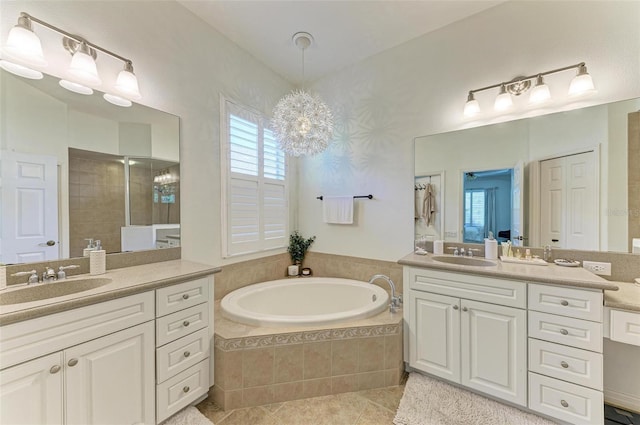 full bathroom featuring tile patterned flooring, two vanities, a sink, and a garden tub