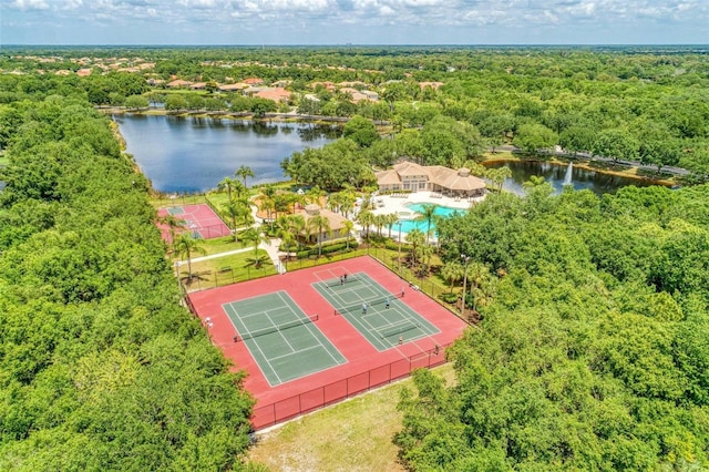 drone / aerial view featuring a water view and a view of trees