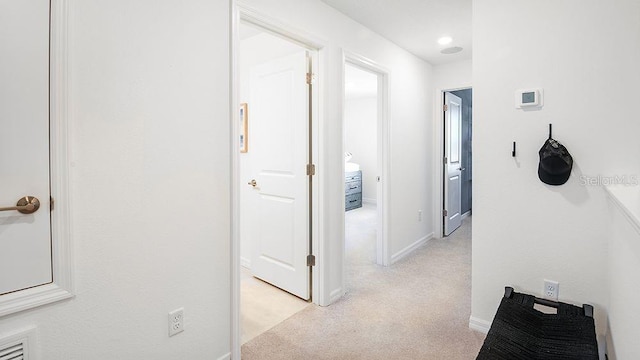 corridor with light carpet and baseboards