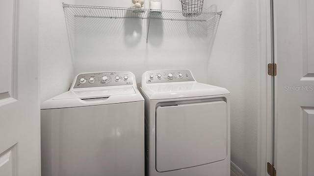 clothes washing area with laundry area and washer and dryer