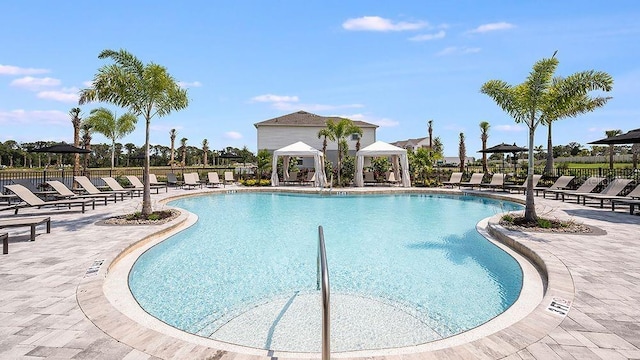 pool featuring fence, a gazebo, and a patio