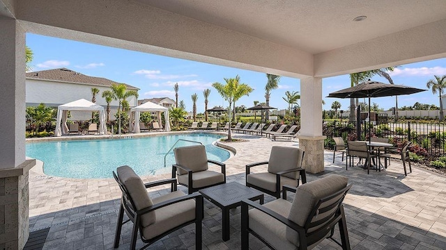 community pool featuring a patio, a gazebo, and fence