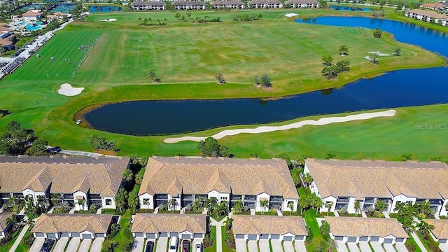 birds eye view of property with a residential view, a water view, and golf course view