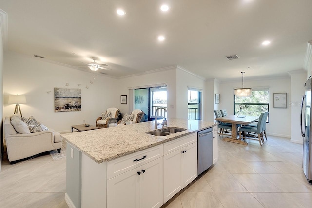 kitchen featuring visible vents, a sink, ornamental molding, stainless steel appliances, and open floor plan