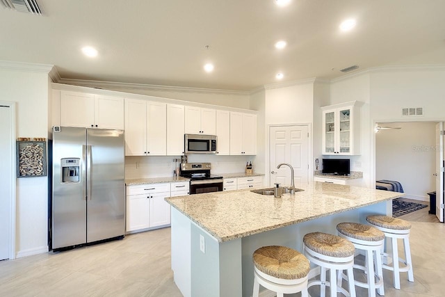 kitchen with a sink, stainless steel appliances, visible vents, and ornamental molding