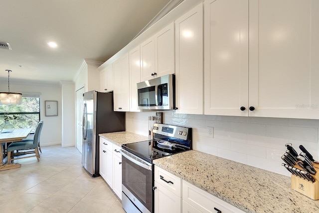 kitchen featuring ornamental molding, tasteful backsplash, appliances with stainless steel finishes, white cabinets, and light stone countertops