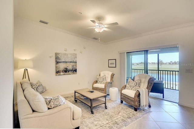 living room featuring ceiling fan, visible vents, light tile patterned flooring, and crown molding