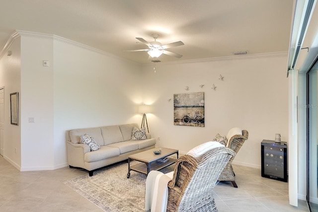 living room with visible vents, crown molding, baseboards, ceiling fan, and light tile patterned floors