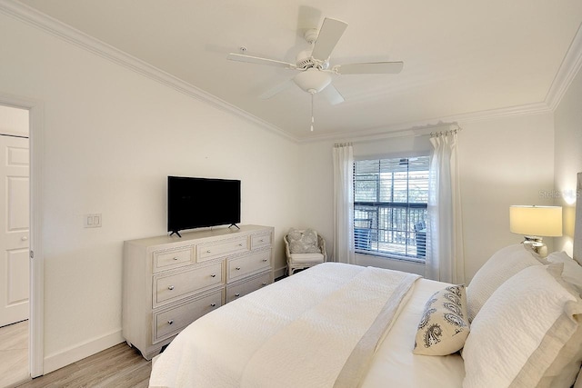 bedroom with ceiling fan, baseboards, light wood-style flooring, and crown molding