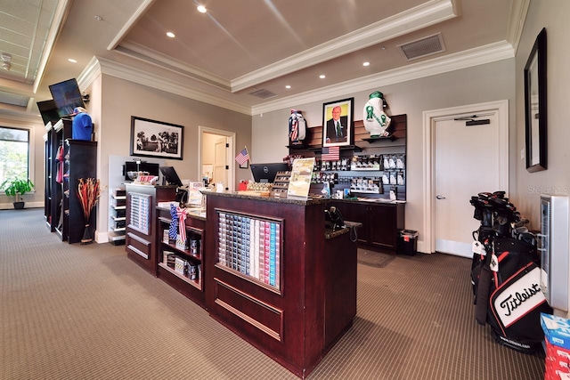 interior space with visible vents, dark carpet, a tray ceiling, and ornamental molding