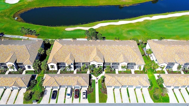 bird's eye view with a residential view, view of golf course, and a water view